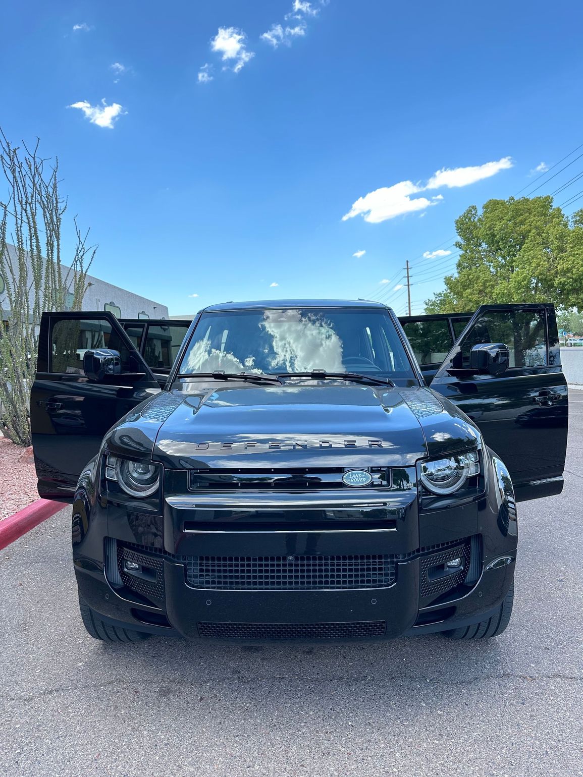 Black Porsche with doors open
 