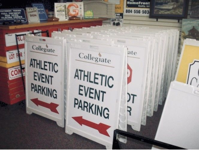 A row of white A-frame signs labeled 