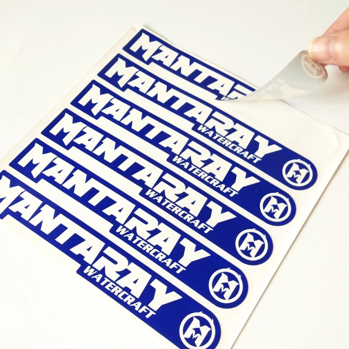 A hand peeling a blue 