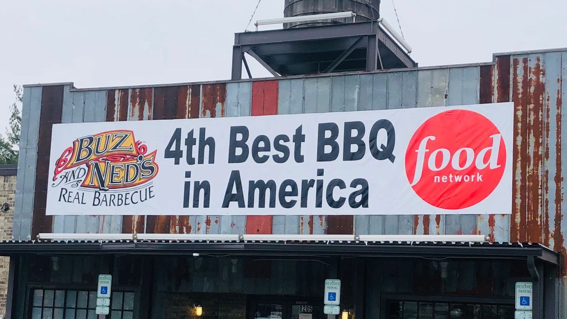 A banner on a rustic building reads 