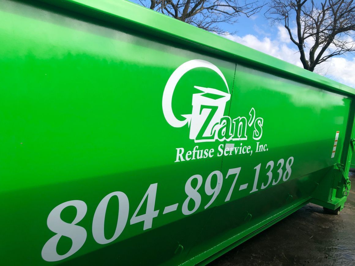 Bright green dumpster with white text that reads 