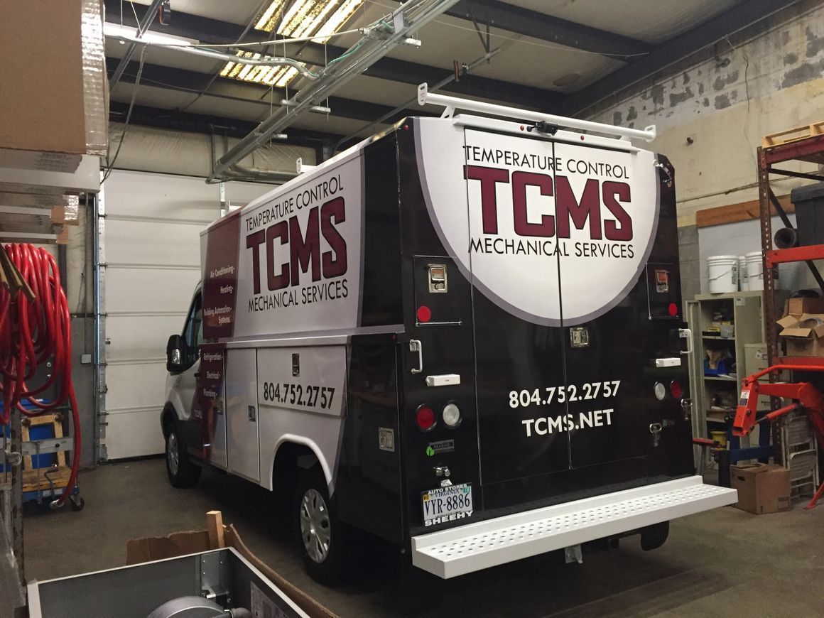A white and black service van branded with 