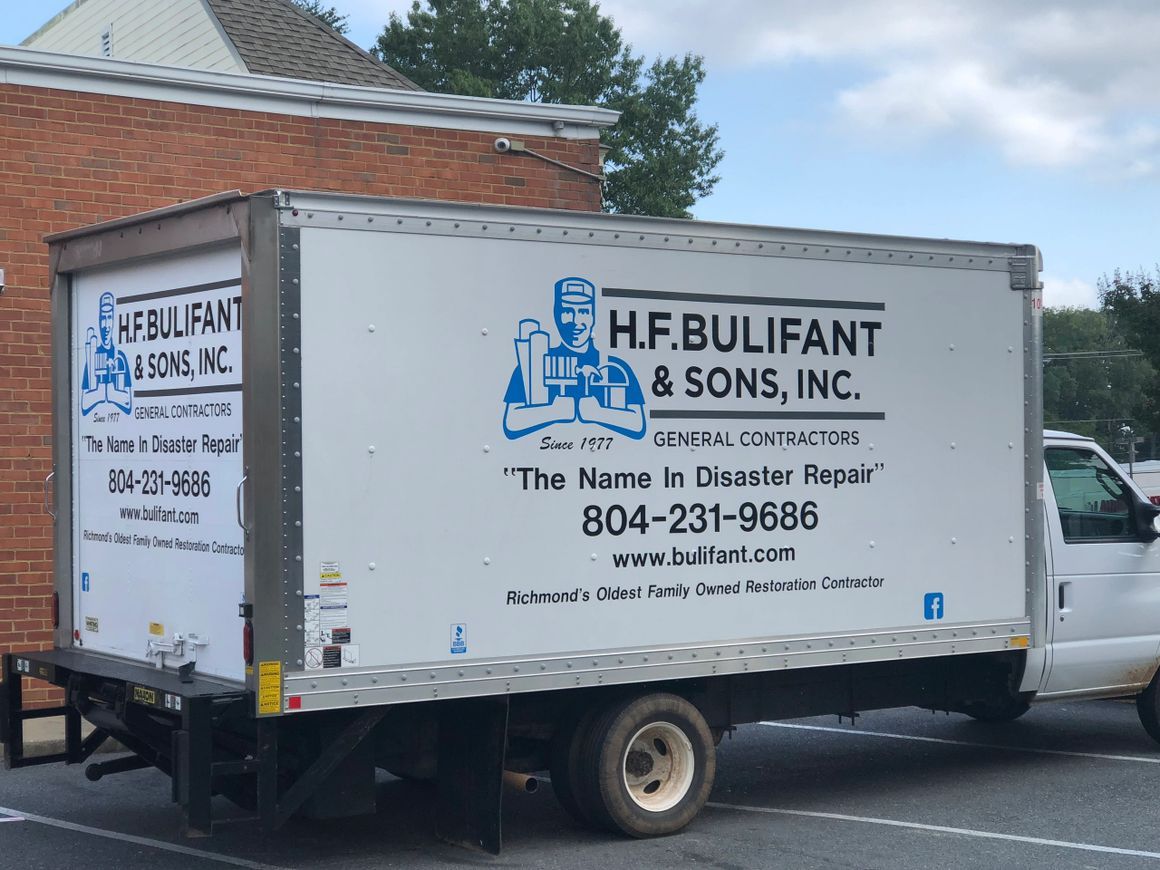 A white H.F. Bulifant & Sons, Inc. box truck parked outdoors, displaying company branding and contact information.