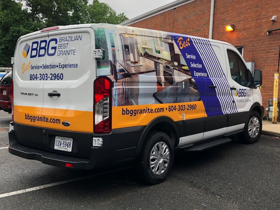 A white Ford work van parked at a brick building features a 
