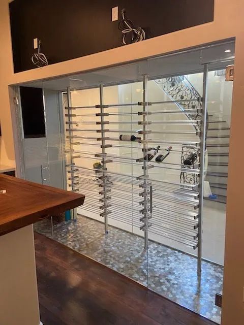 Glass front door with horizontal metal security bars in a modern interior hallway