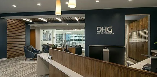 Reception area with blue walls, wood accents, and DHG logo.