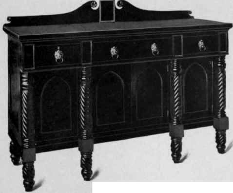 Dark wooden sideboard with three drawers, arched panels, and turned legs.