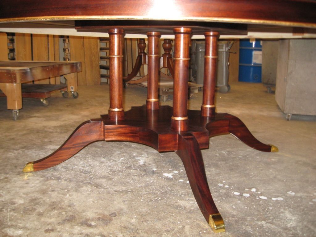 Dark wood dining table base with six vertical supports and curved legs.