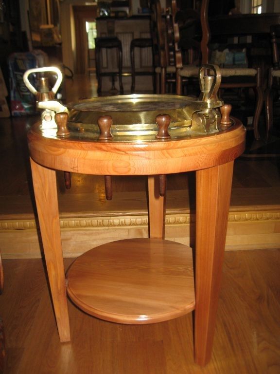 Wooden side table with brass top and handles; built-in lower shelf.