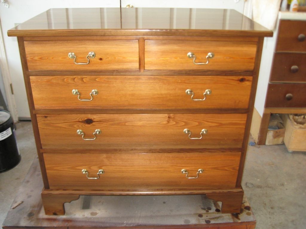 Wooden dresser with four drawers, two small top drawers, and a glossy finish.