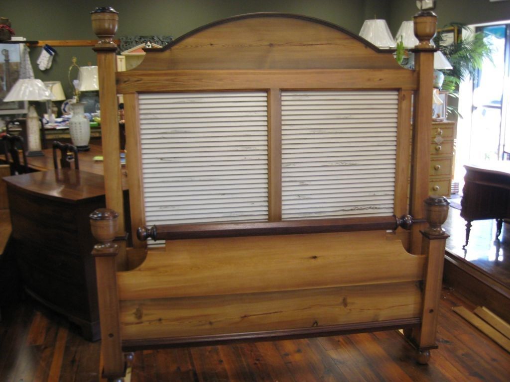 Wooden antique bed frame in a furniture store.
