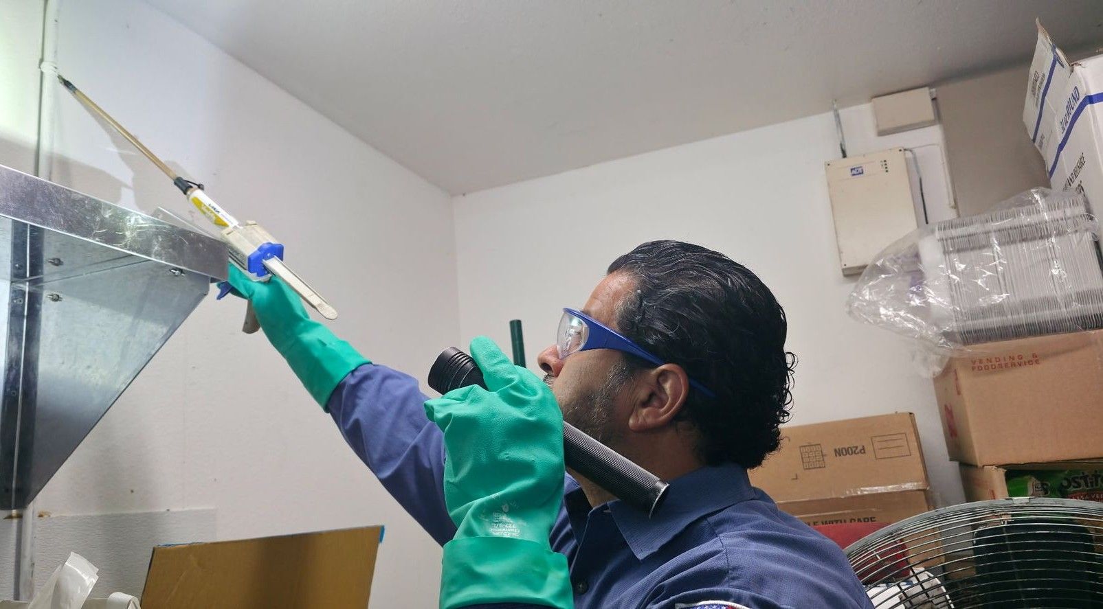 A group of people in blue shirts stand outside a building with a blue dome. Sunny day.