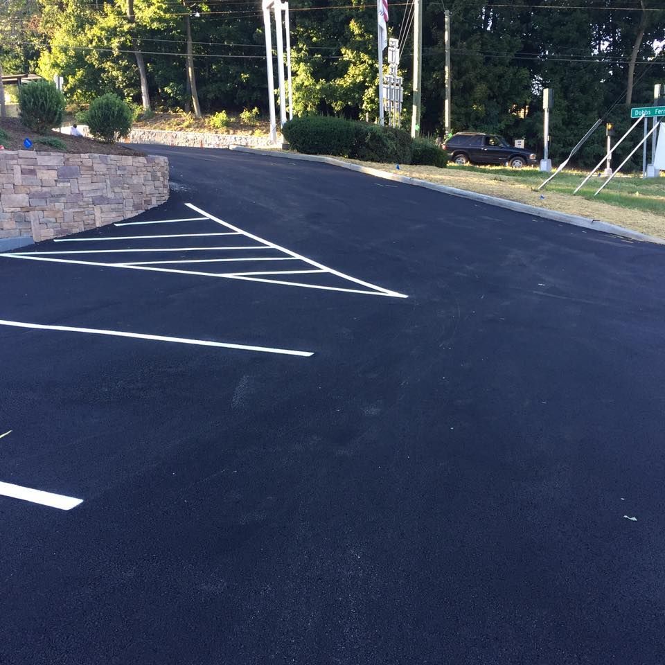 A black asphalt road with white lines on it