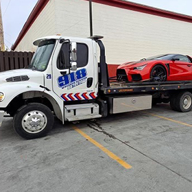 truck towing red car