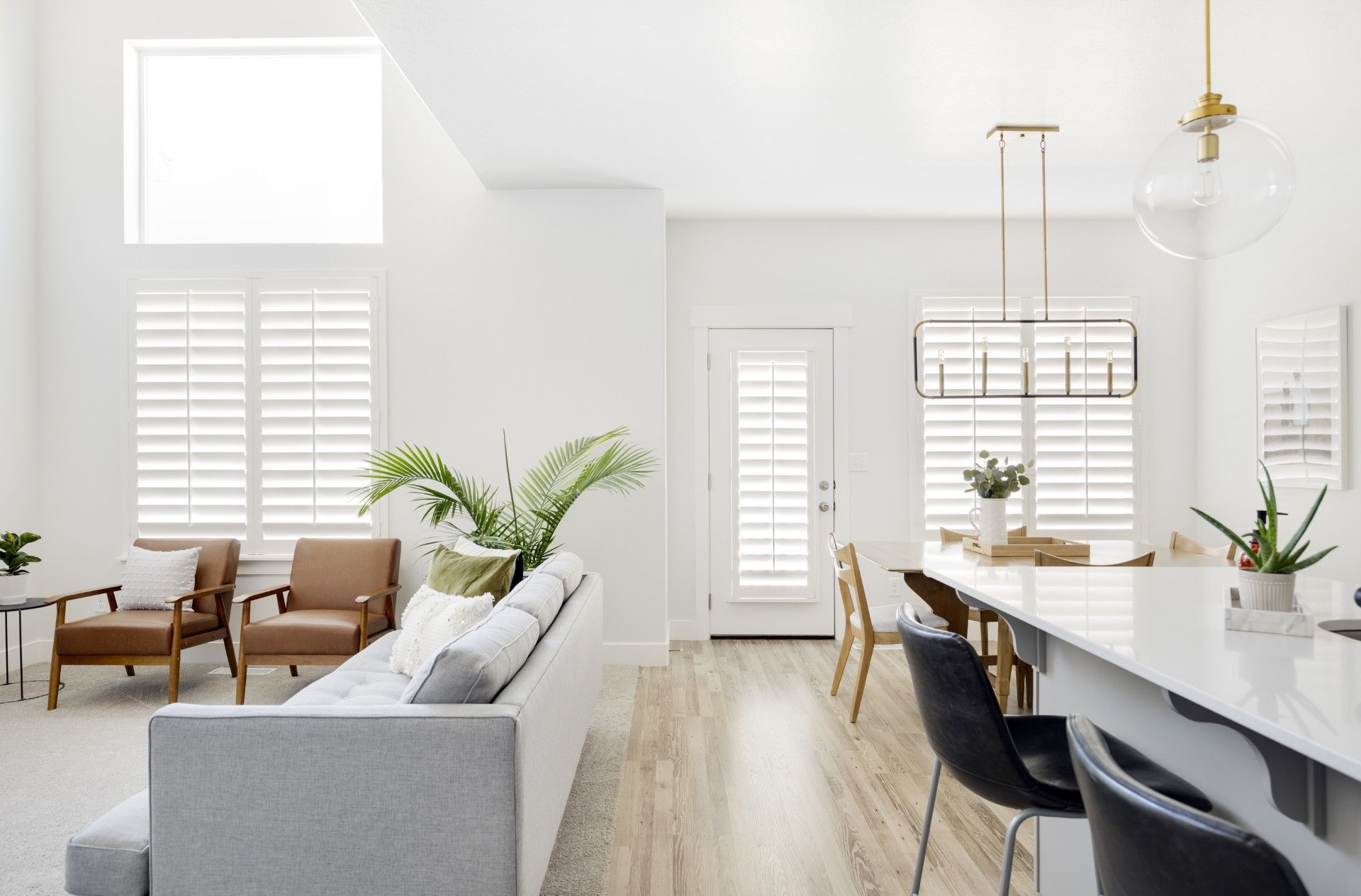 A living room with a couch , chairs , and a table.