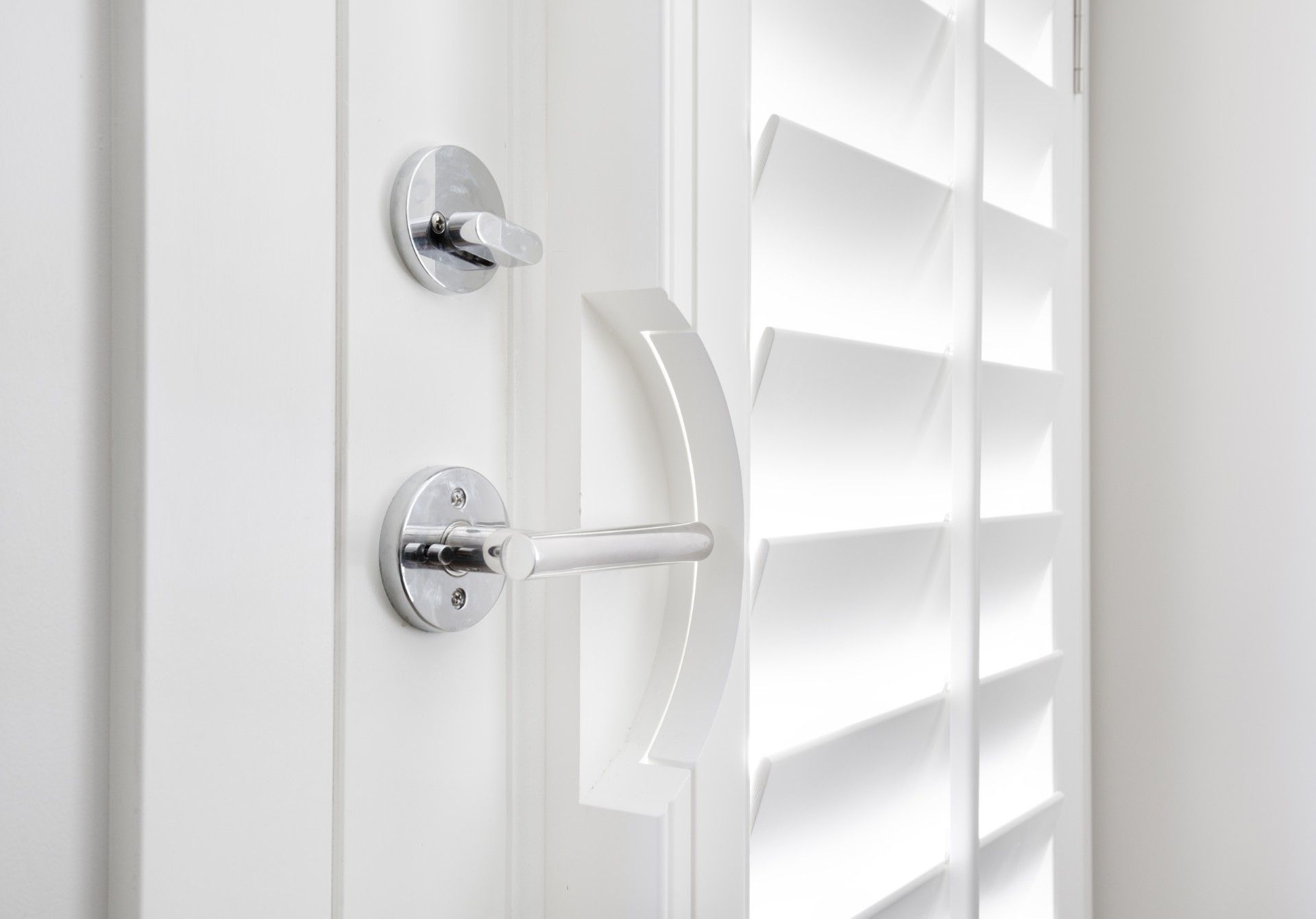 A close up of a door with shutters and a handle