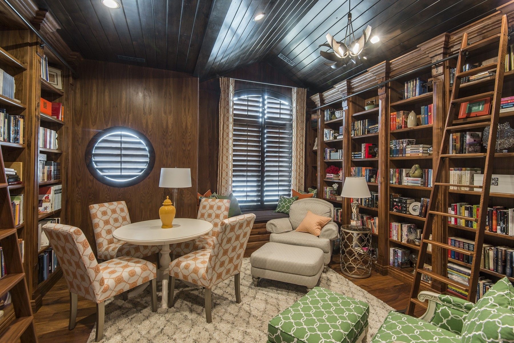 A living room filled with furniture and bookshelves.