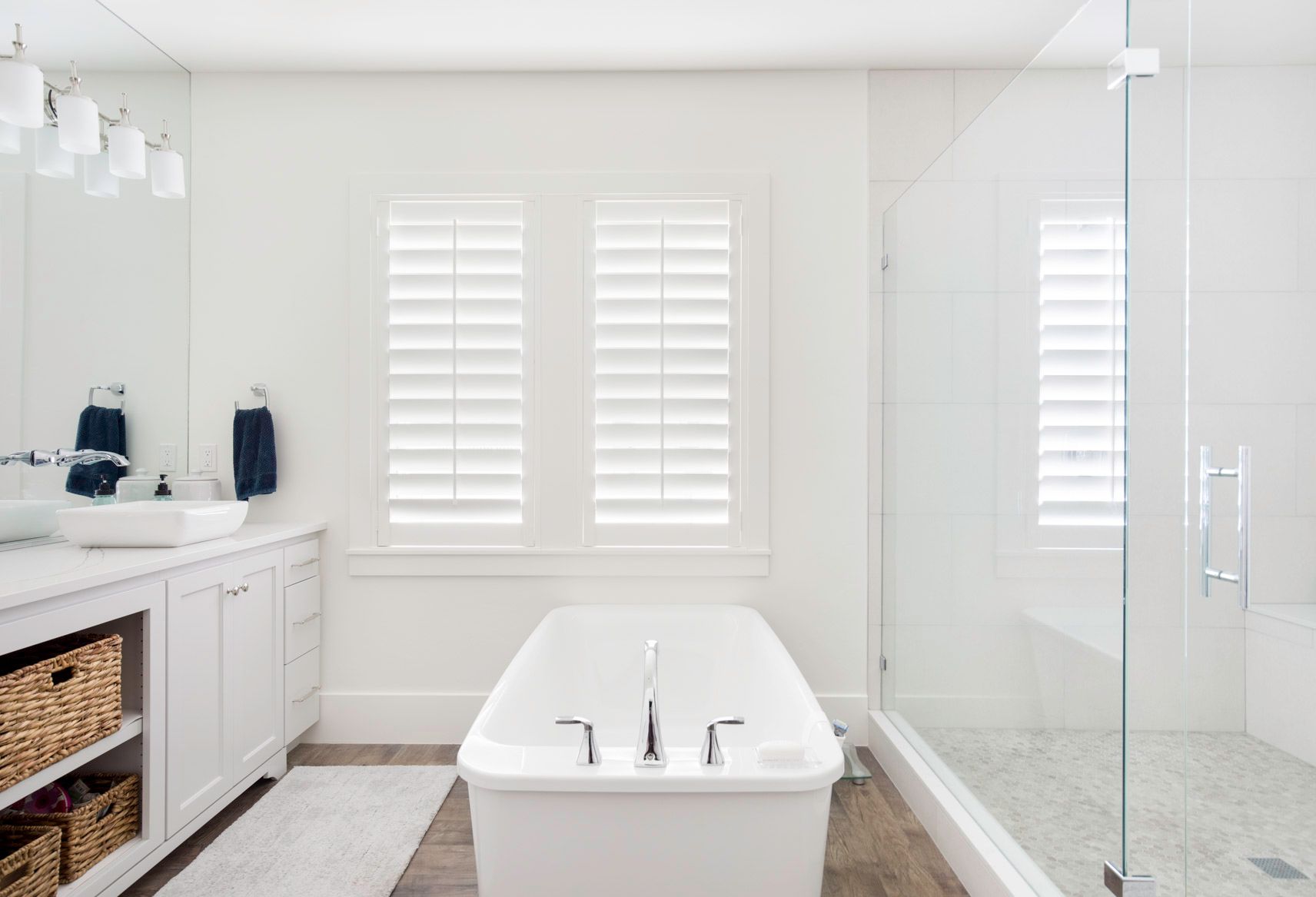 A bathroom with a tub , sink , and shower.
