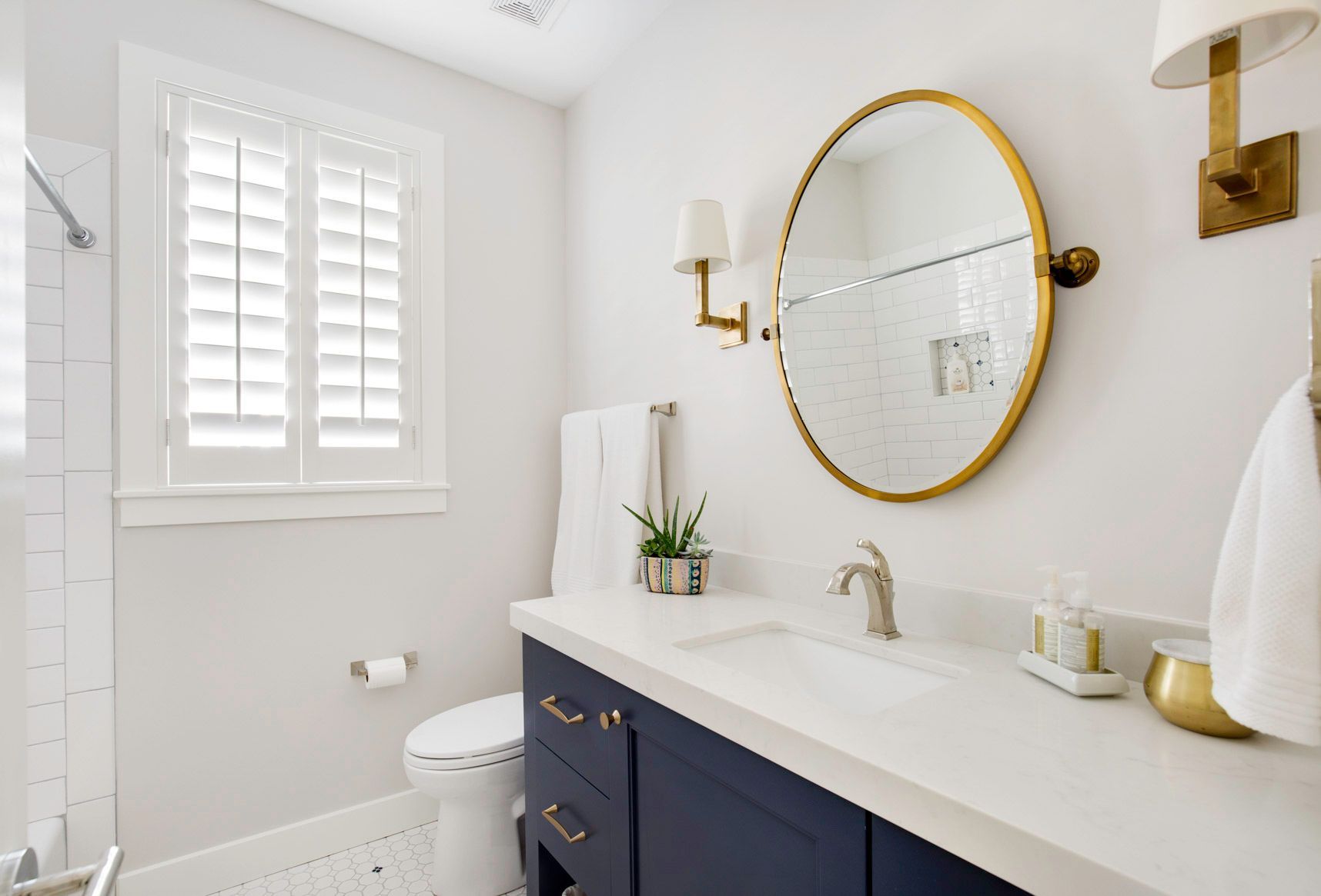 A bathroom with a sink , toilet , and mirror.