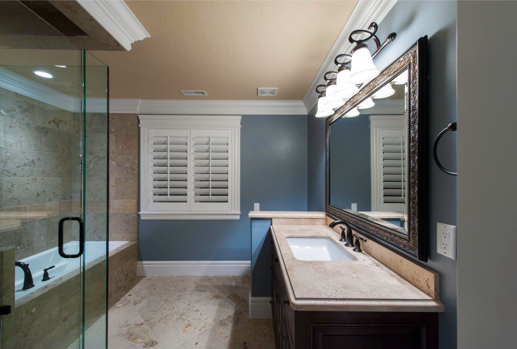 A bathroom with two sinks and a large mirror