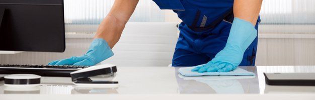 Worker cleaning desk