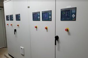 A control panel with a lot of buttons and monitors on it.