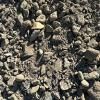 A pile of rocks is sitting on the ground.