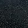 A close up of a black carpet texture.