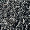 A close up of a pile of black shredded metal.