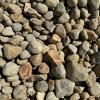 A pile of rocks sitting on top of each other on the ground.