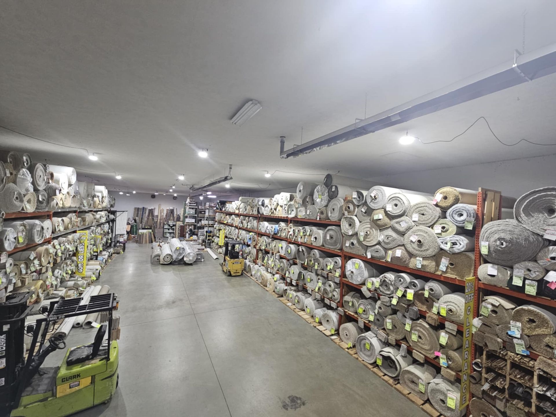 A large warehouse filled with lots of rolls of fabric.