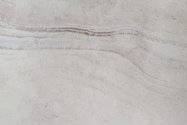 A close-up of a white tile with a marble texture.
