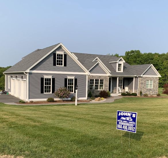 A house with a for sale sign in front of it