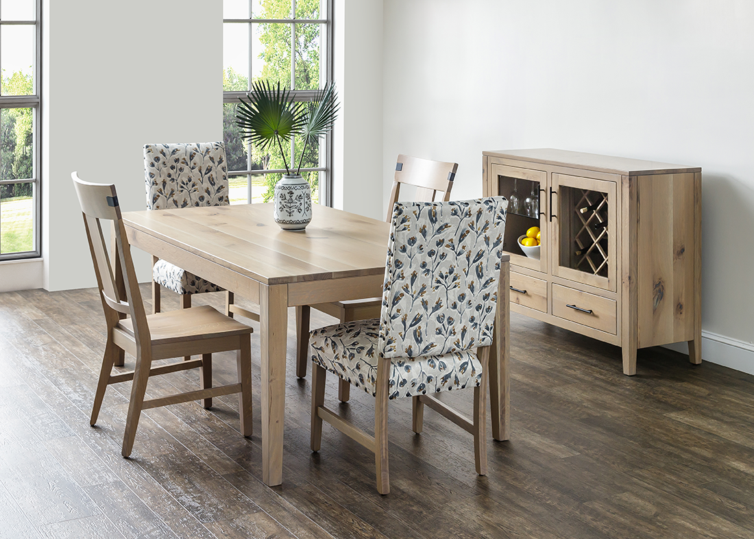 A dining room with a table and chairs and a wine cabinet.