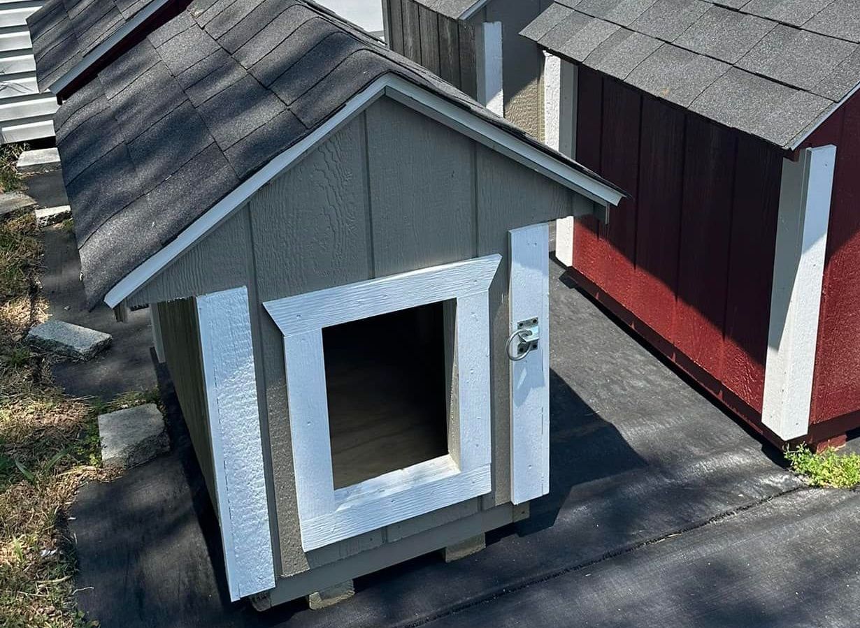 A small dog house with a window on the side of it