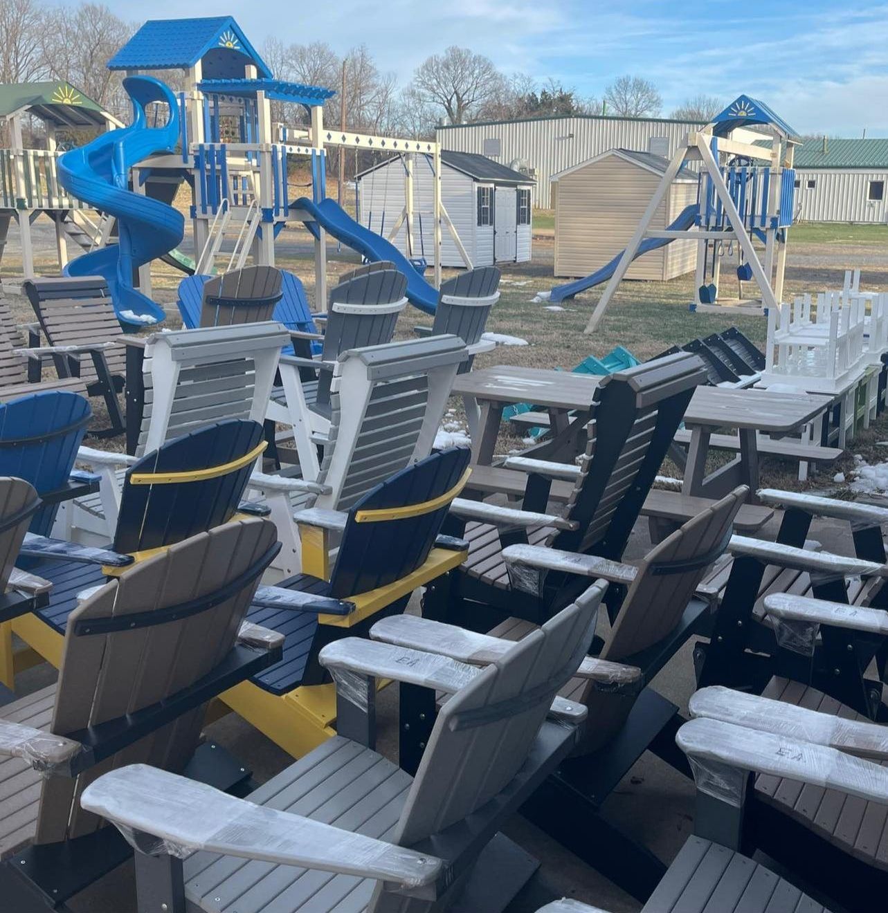 A bunch of chairs are lined up in front of a playground