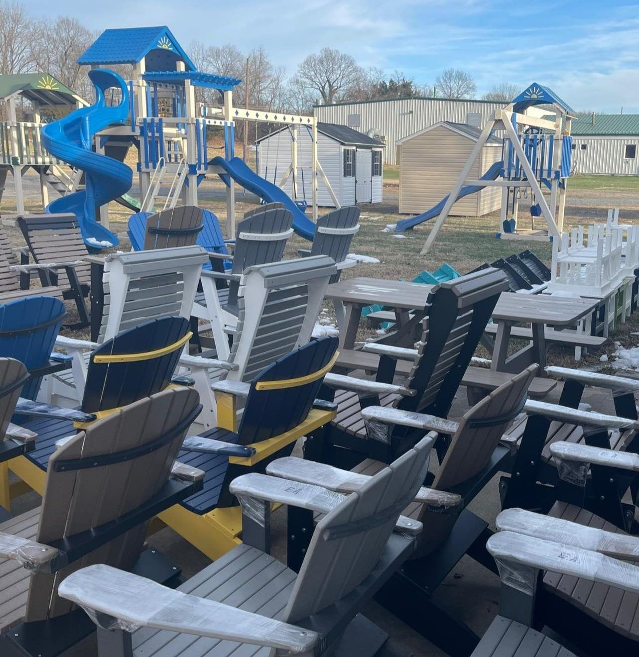 A bunch of chairs are lined up in front of a playground