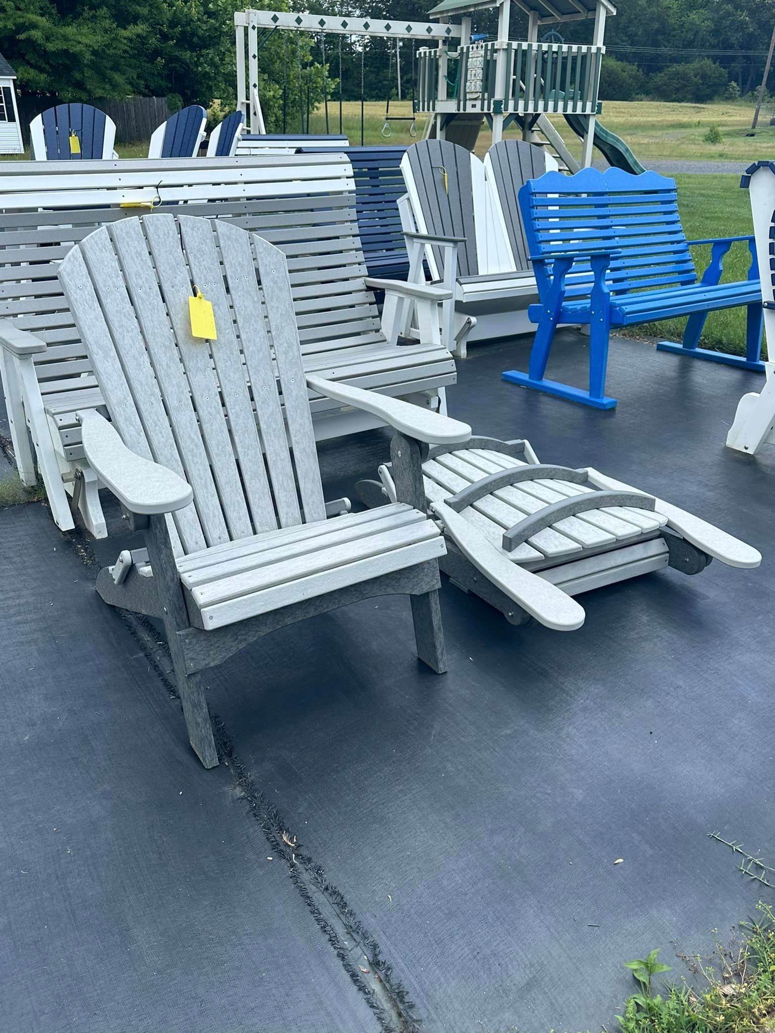 A bunch of lawn chairs are sitting on the side of the road.