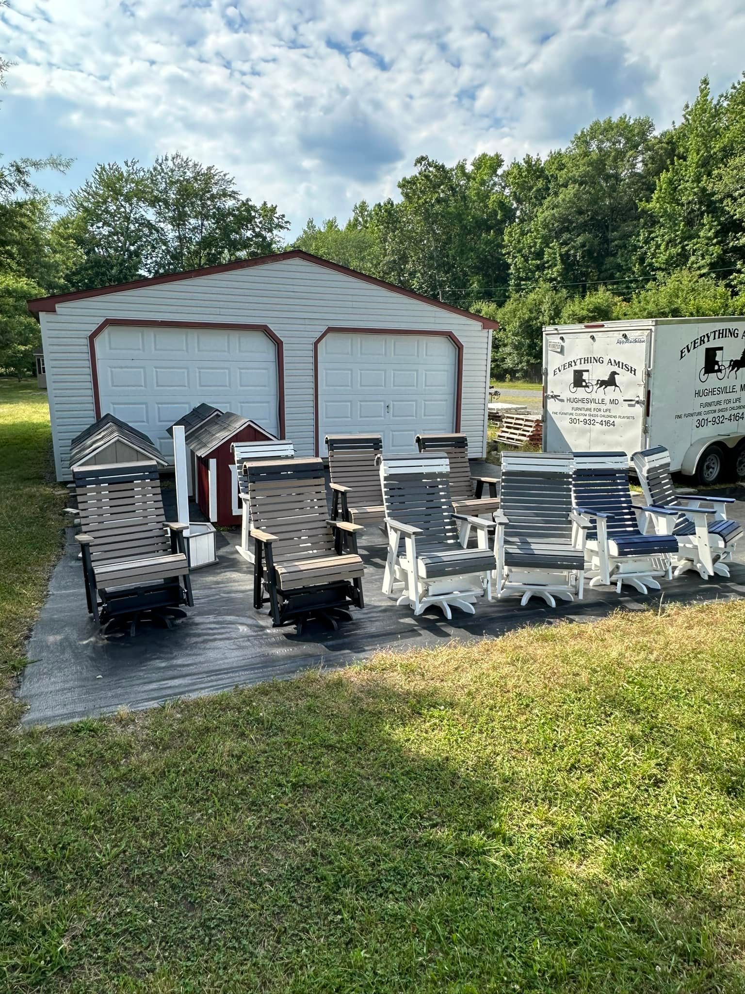 A bunch of chairs are sitting in front of a garage.