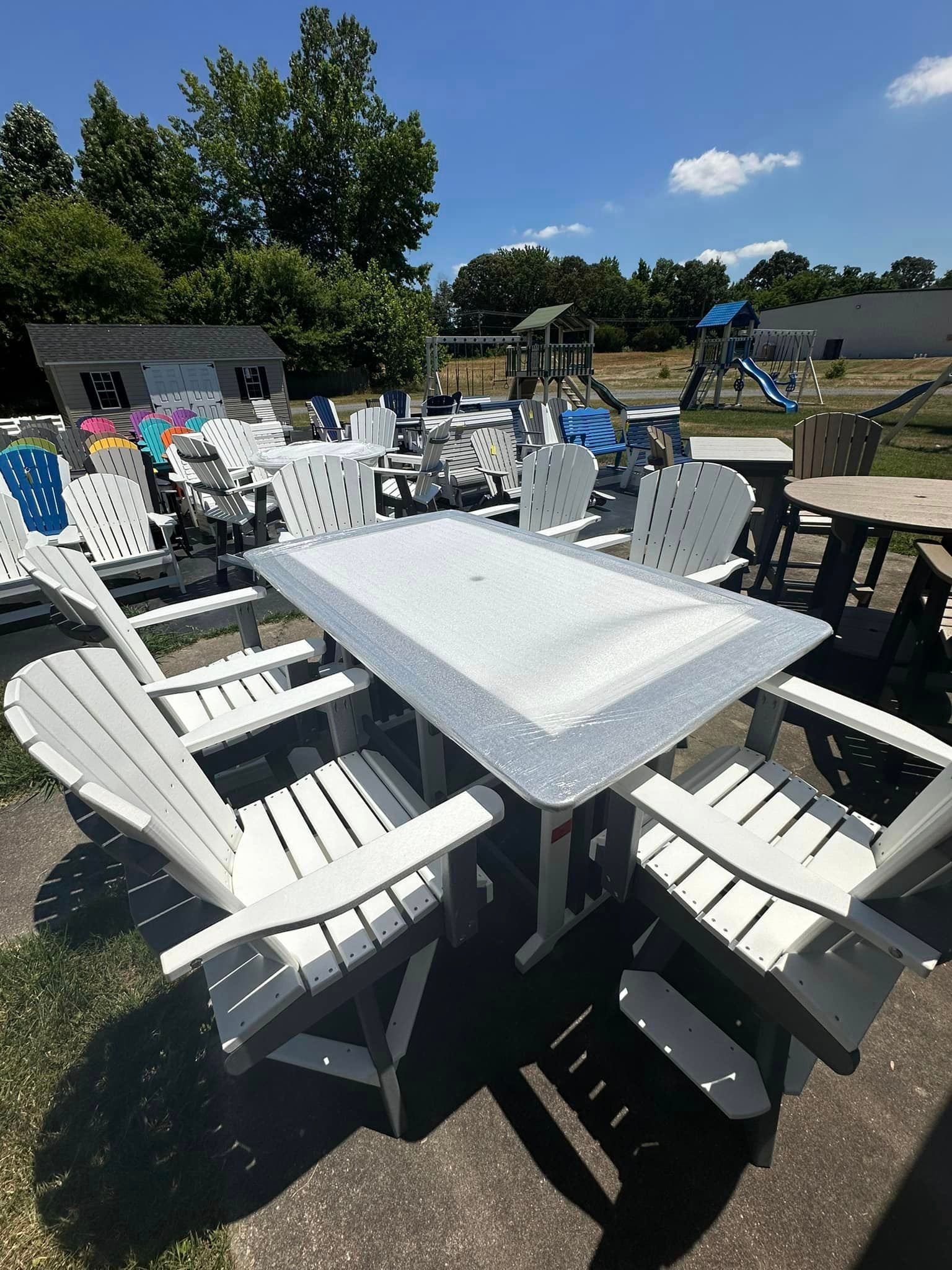 A table and chairs are sitting on the ground in a yard.