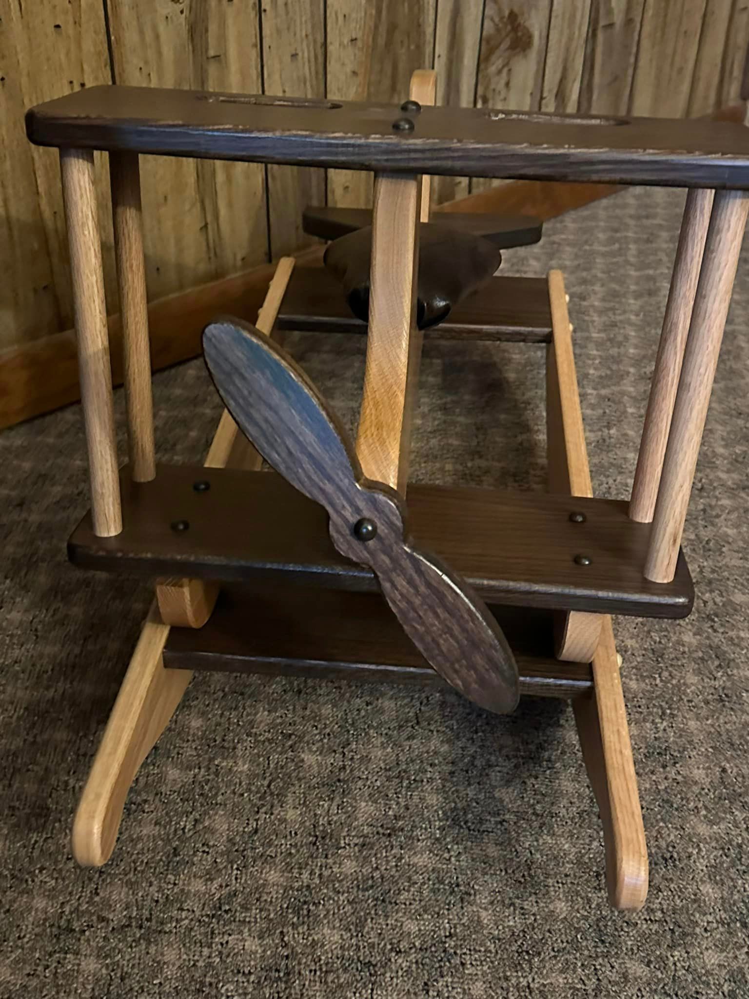A wooden rocking chair with a propeller on it.