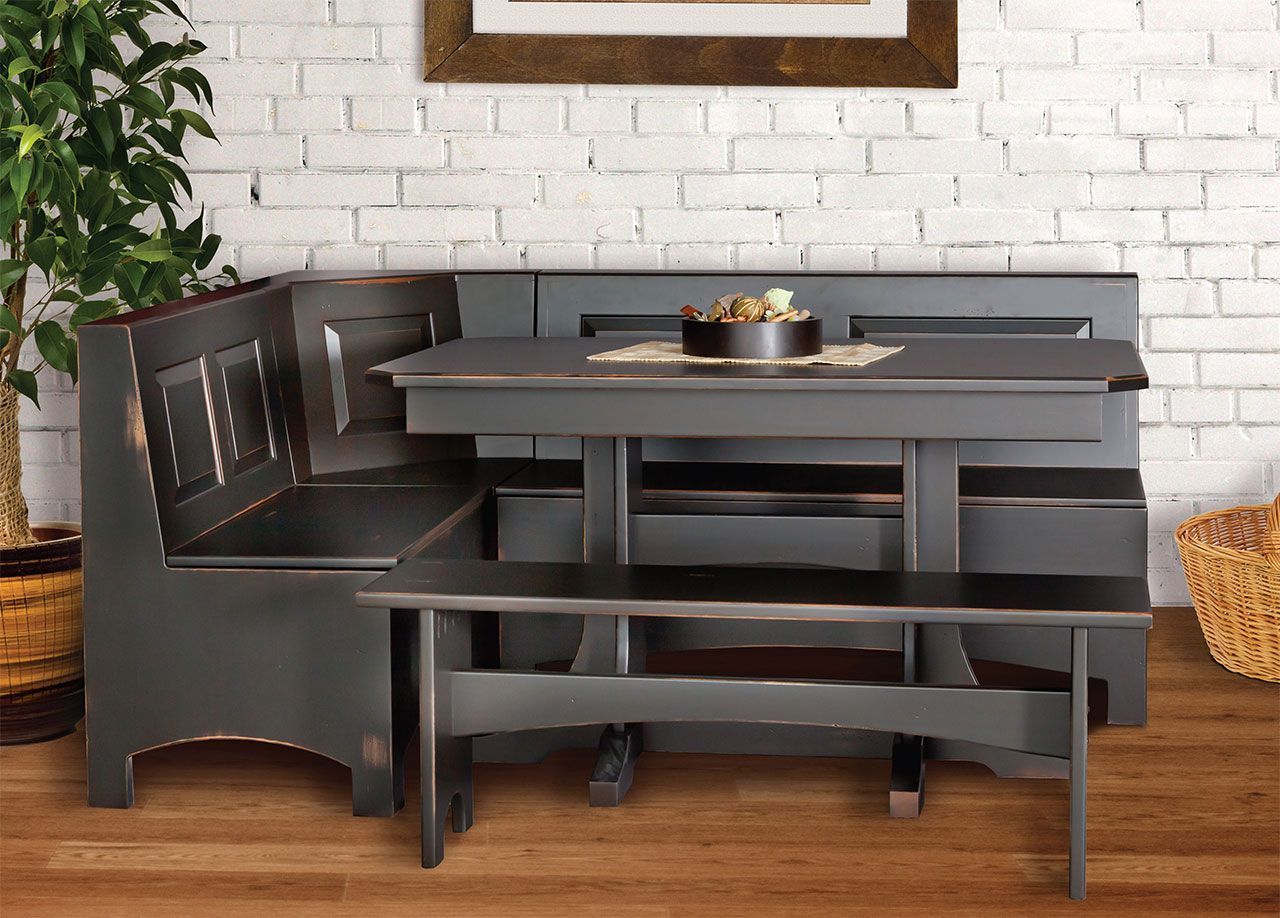 A corner dining room set with a table and benches