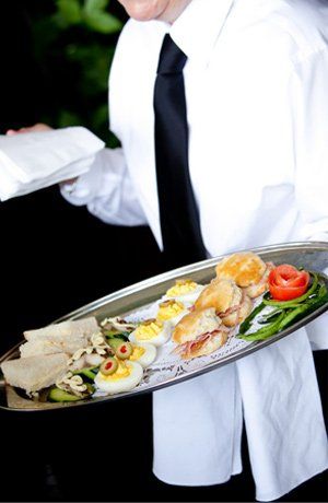 Catering waiter serving food