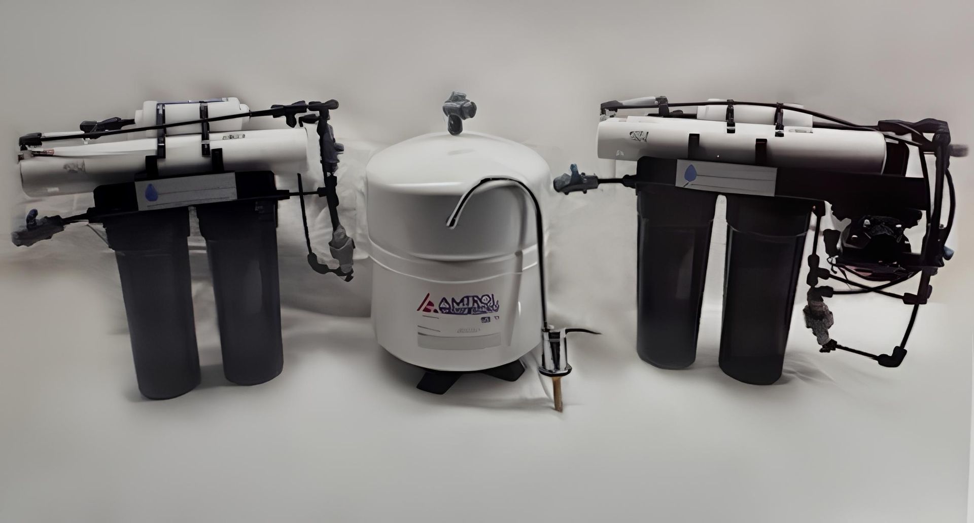 Two reverse osmosis water filtration systems flanking a water storage tank, with a faucet.