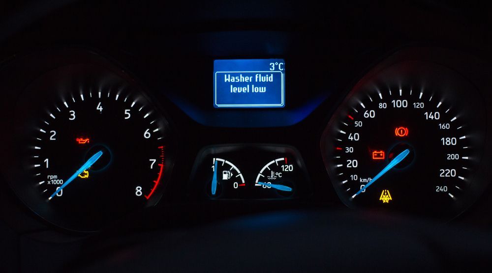 Dashboard gauges and display showing warning lights and a temperature of 3°C.