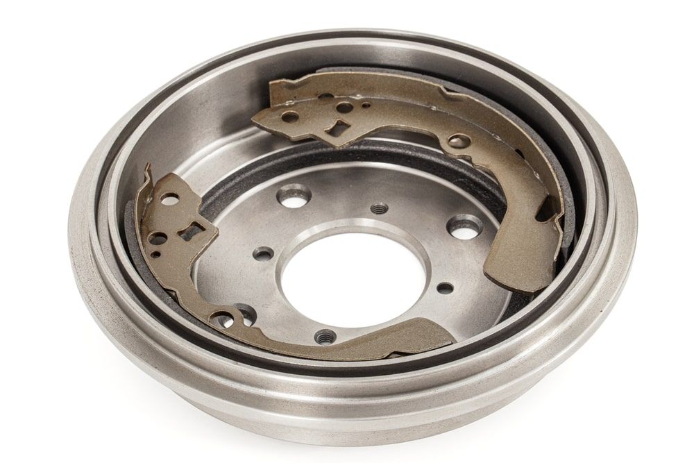 Brake drum assembly with brake shoes inside; metal components.