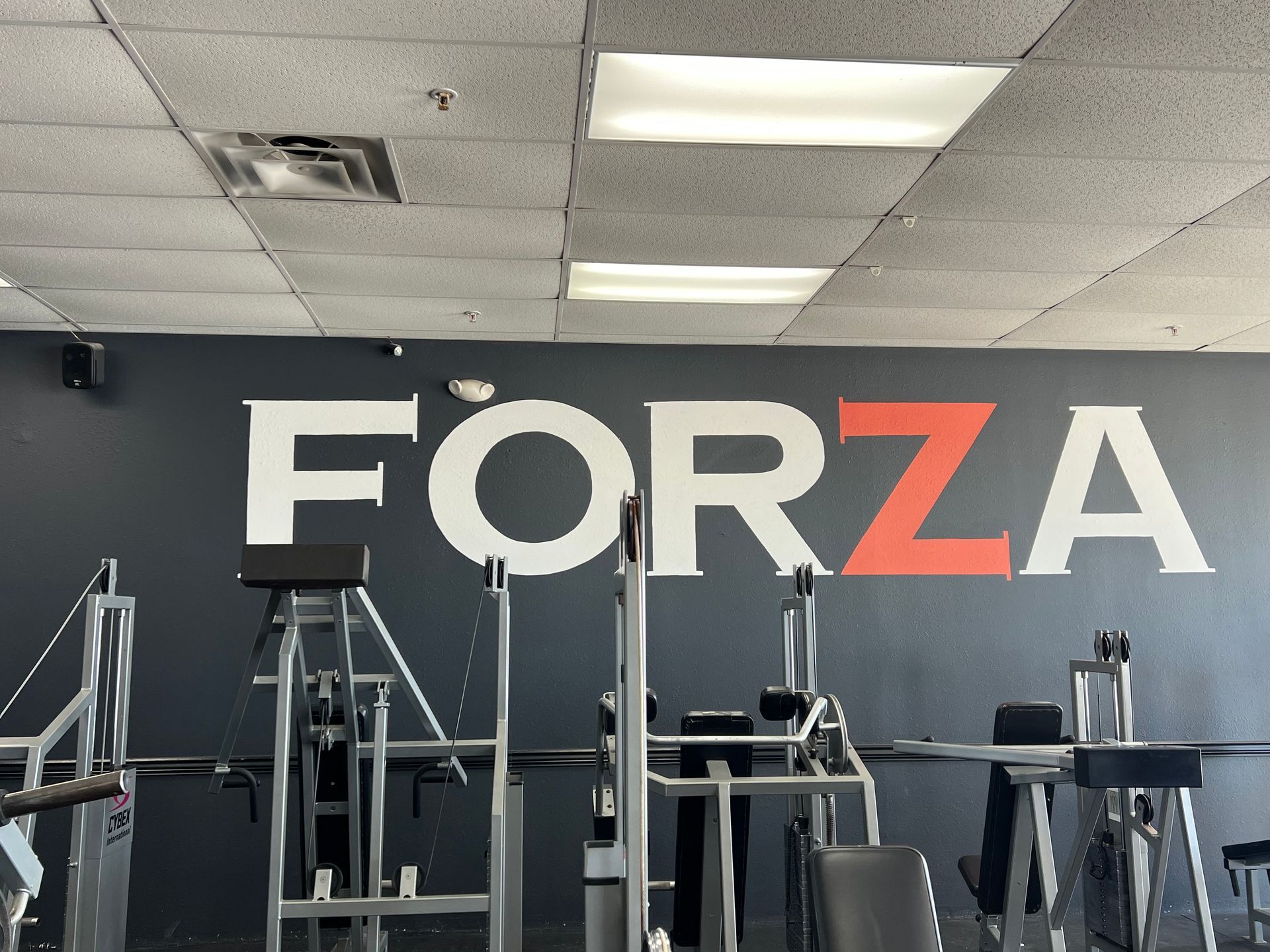 Gym interior with FORZA on the wall.