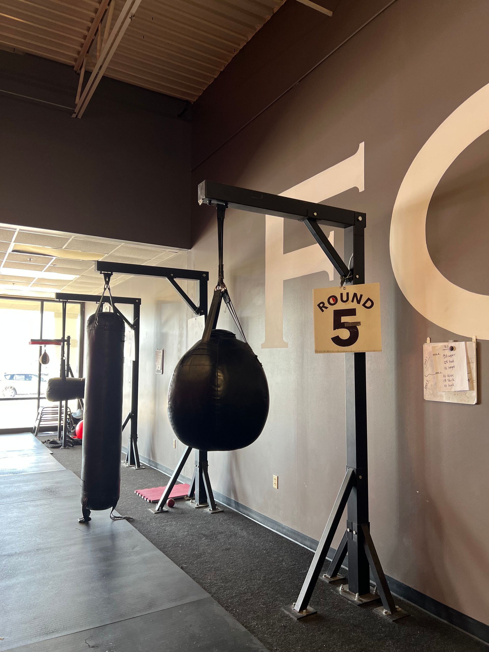 Boxing gym interior with heavy bags, and speed bag.