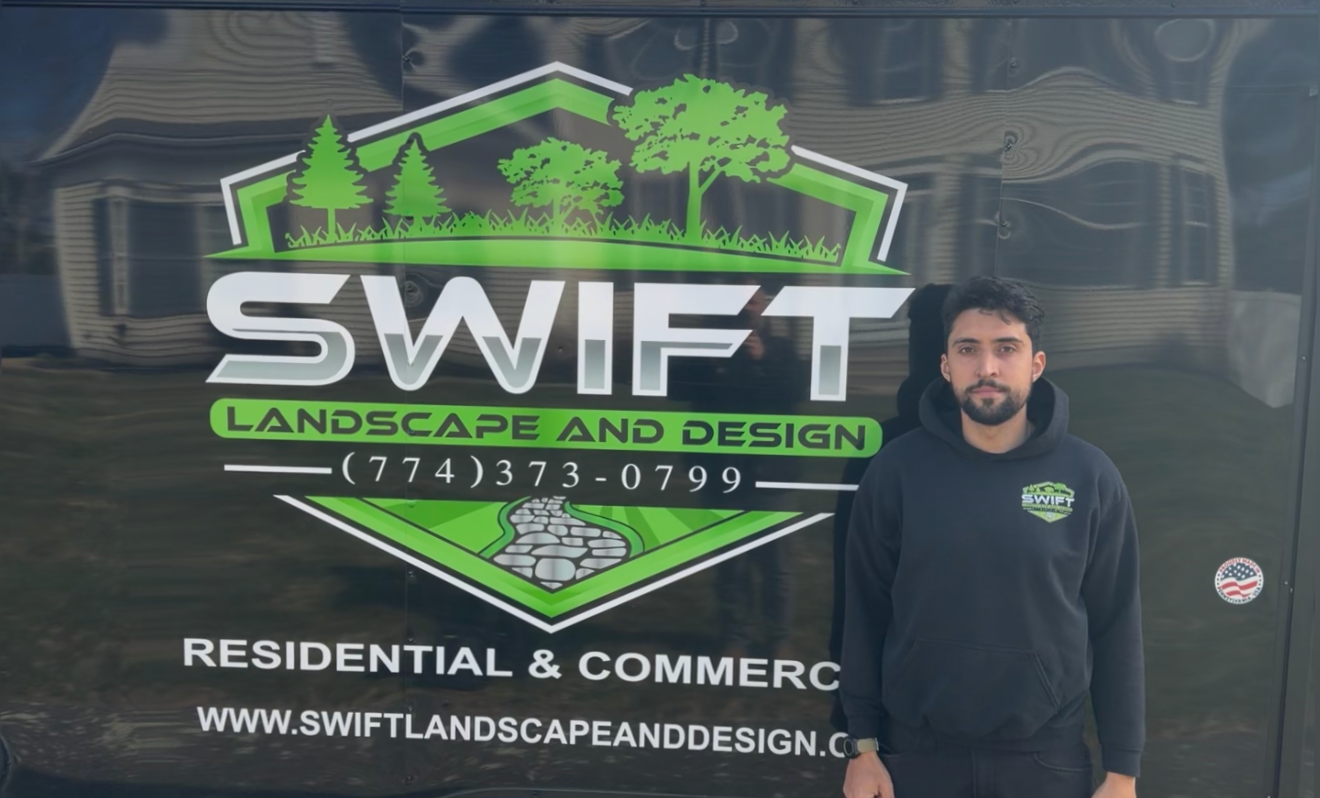 Swift Landscape and Design logo on a truck, with a man standing beside it