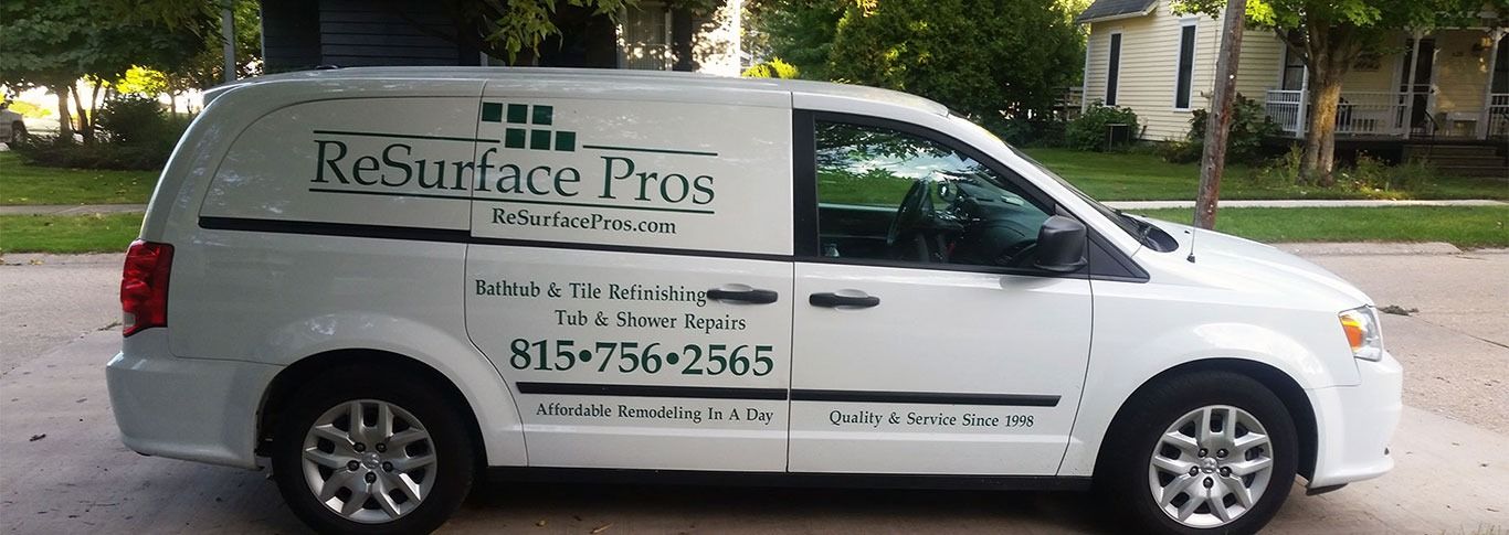 White funeral service van with company branding and phone number parked on a street.